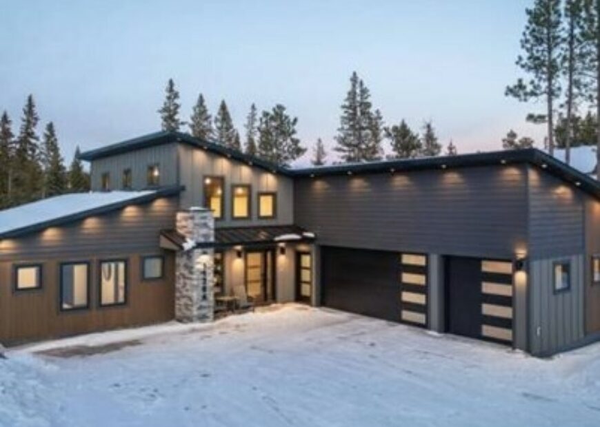 modern cabin in the snow covered woods