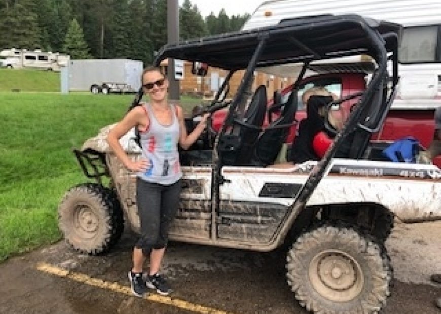 Woman standing in front of a four-wheeler